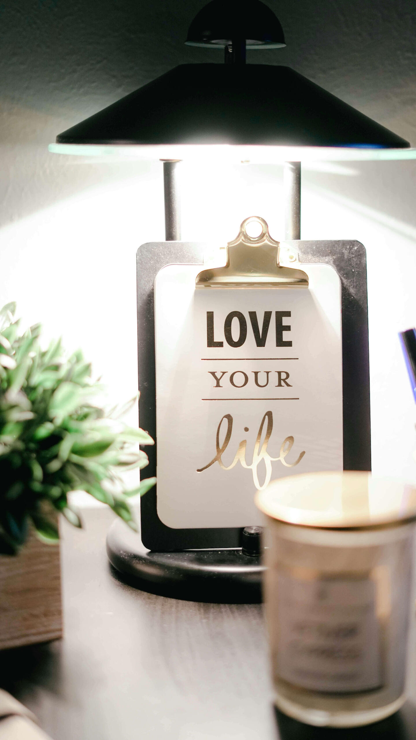 Love Your Life sign next to some flowers and a candle